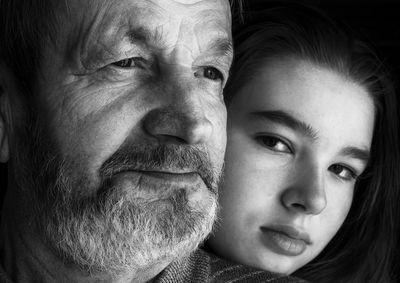 Close-up portrait of girl with grandfather 