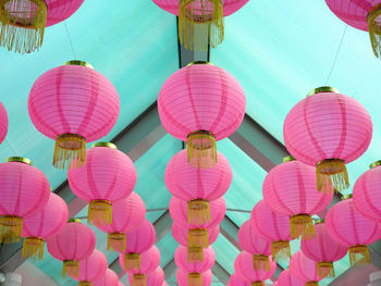 Low angle view of multi colored lanterns hanging in row