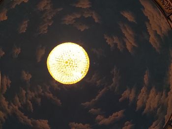 Low angle view of illuminated lamp against sky at night