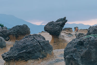 Low angle view of rock formations against sky