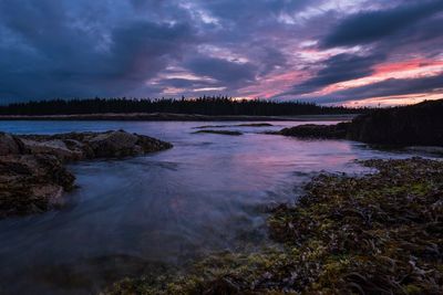 Scenic view of river against sky during sunset