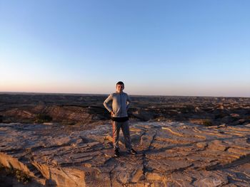 Full length of young man standing on rock