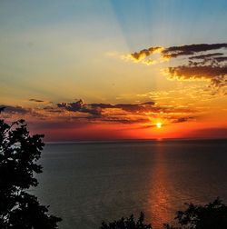 Scenic view of sea against romantic sky at sunset