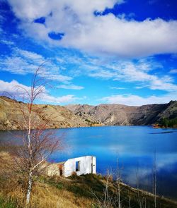 Calm lake with mountains in background