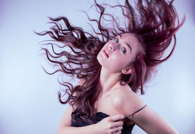 Young woman against blue background