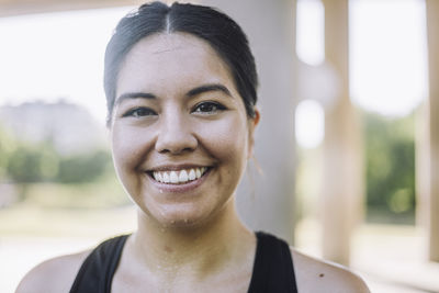 Portrait of happy woman with sweat on face