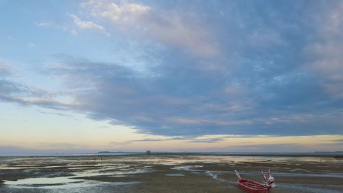 Scenic view of beach against sky during sunset