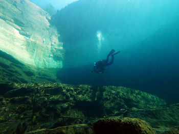 People diving in quarry, lake