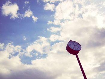 Low angle view of street light against cloudy sky