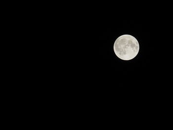 Low angle view of full moon against sky at night