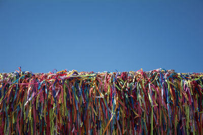 Low angle view of colorful ribbons against clear sky