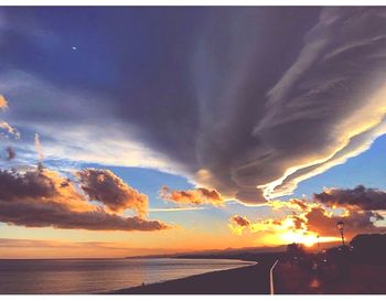 Scenic view of dramatic sky over sea during sunset