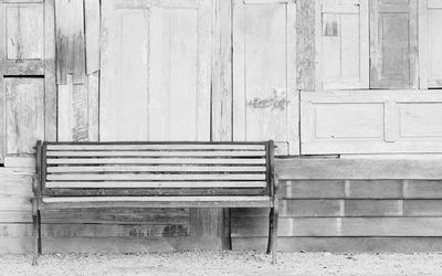 Empty bench against wall