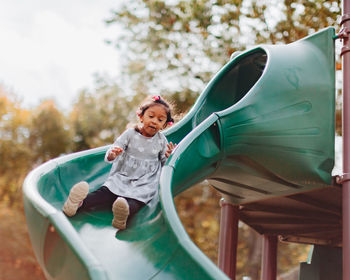 Full length of cute girl on slide at park