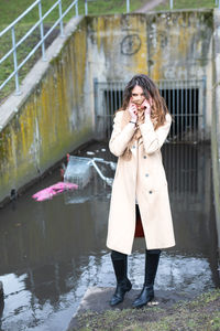 Full length of woman standing in water