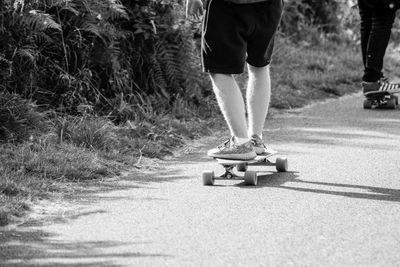 Low section of man skateboarding