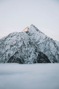 Scenic view of snowcapped mountains against clear sky