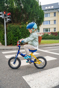 Boy riding push scooter on street