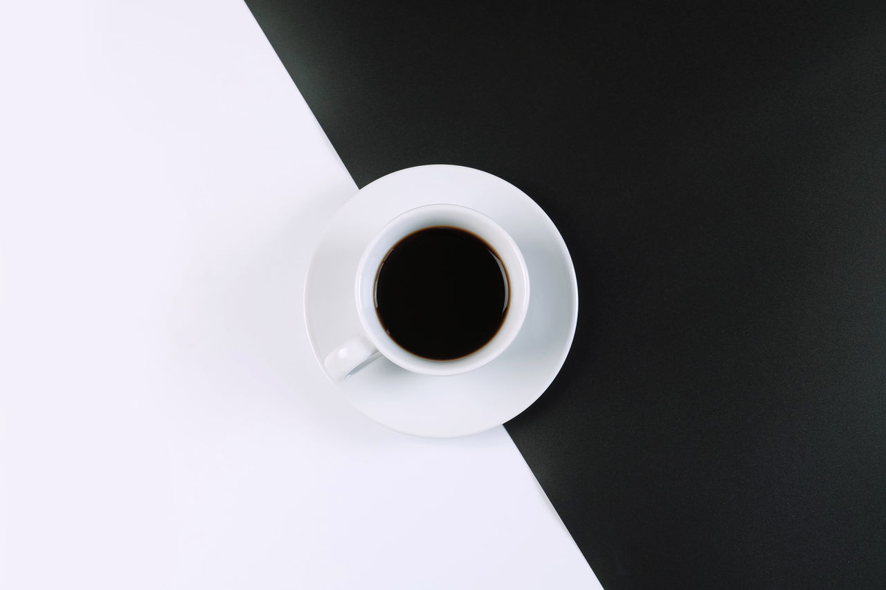 HIGH ANGLE VIEW OF COFFEE CUP AND BLACK BACKGROUND