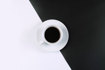 High angle view of coffee cup against black background