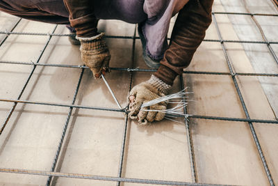 Low section of man working on floor