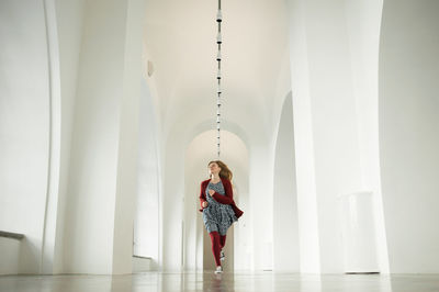 Woman standing against wall