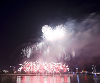 Low angle view of firework display at night