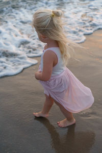 Little girl on the beach in the summer.