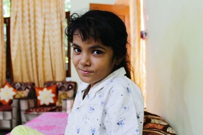 Close-up portrait of girl sitting at home