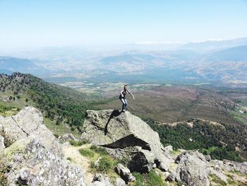 Scenic view of rocks and mountains against sky