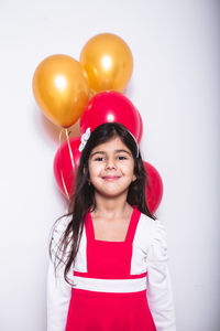 Portrait of a smiling young woman against white background
