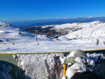 Scenic view of snowcapped mountains against clear blue sky