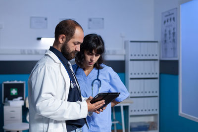 Doctor and nurse looking at digital tablet