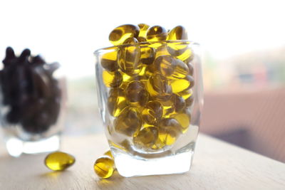 Close-up of yellow glass on table