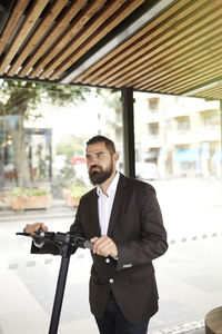 Businessman holding scooter