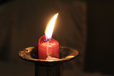 High angle view of illuminated candle in room