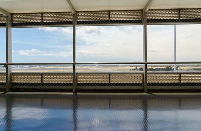 Airport runway seen through glass window