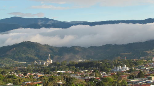 Town by mountains against sky