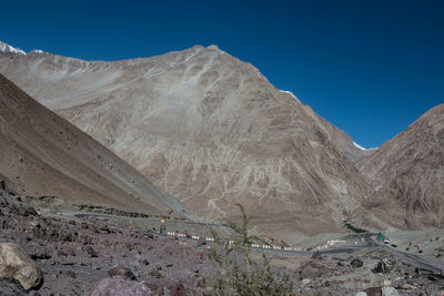 Scenic view of mountains against clear blue sky