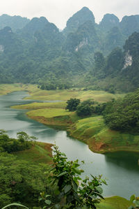 Scenic view of lake and mountains against sky