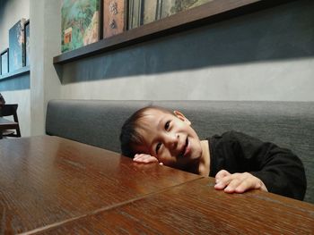 Portrait of boy on table