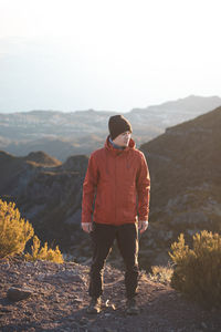 Traveller with smile enjoys view from pico ruivo, highest mountain on portuguese island of madeira