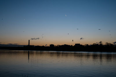 Scenic view of lake against sky during sunset
