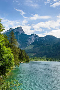 Scenic view of lake and mountains against sky