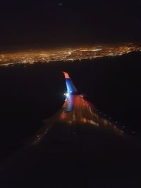 Aerial view of city against sky at night