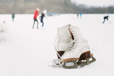 Close-up of shoes on snow covered landscape