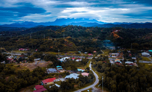 High angle view of city and mountains against sky