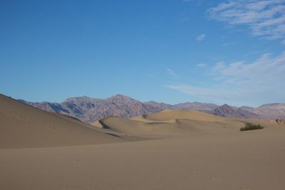 Scenic view of desert against clear blue sky