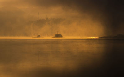 View of sea against cloudy sky during sunset