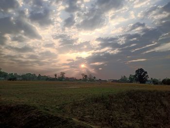 Scenic view of field against sky during sunset